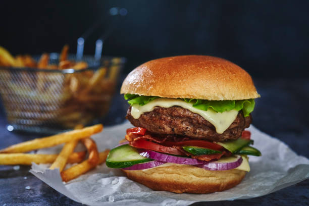istock Beef Burger with Tomatoes, Cucumber, Onions and Salad 1295990727