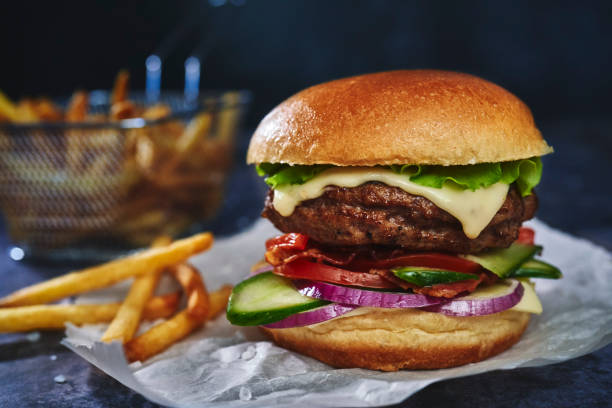 istock Beef Burger with Tomatoes, Cucumber, Onions and Salad 1295990898