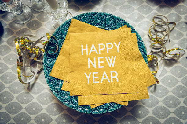 New year table setting with exclusive and luxury golden cutlery, with decoration and christmas decor over a tabletop with celebrations world \