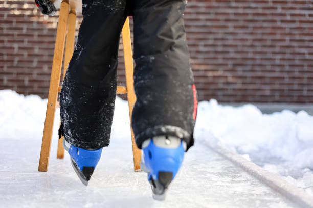 istock Cute Boy Learning to Ice Skate in Backyard in Winter 1295991695