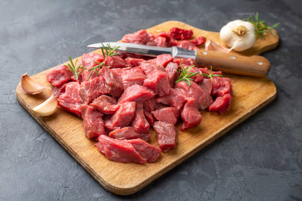 istock Heap of raw chopped beef isolated on cutting board 1295991825