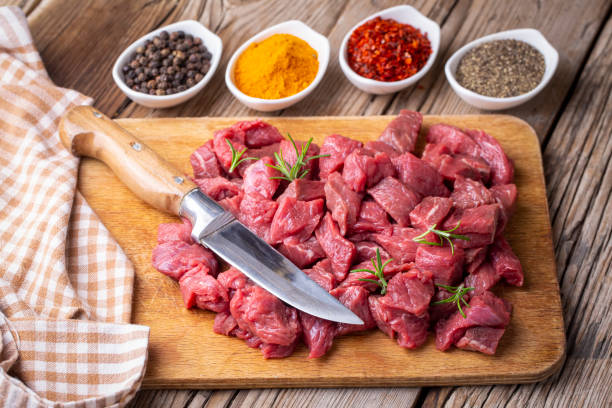 istock Heap of raw chopped beef isolated on cutting board 1295991873
