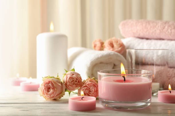istock Pink scented candles on white wooden background 1295991877