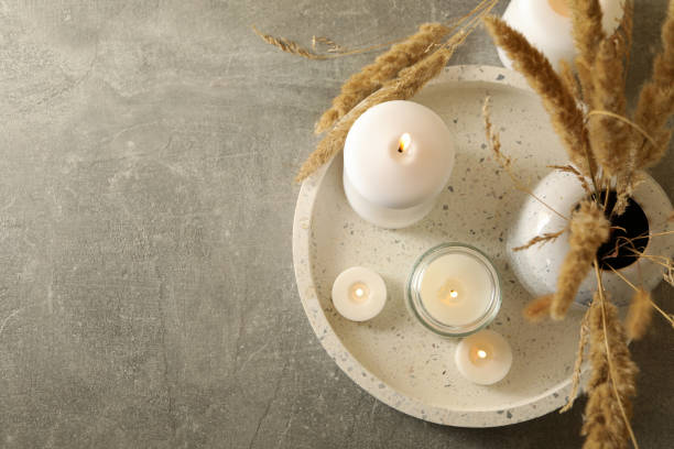 istock Tray with scented candles and reed on gray table 1295991926