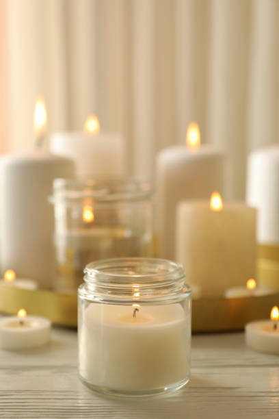 istock Burning scented candles for relax on white wooden table 1295991941