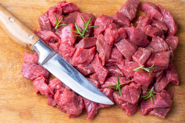 istock Heap of raw chopped beef isolated on cutting board 1295992062