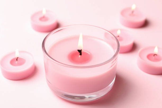 istock Scented candles for relax on pink background 1295992101