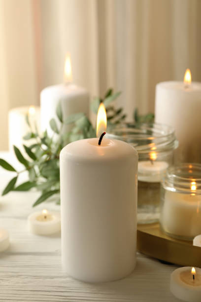 istock Burning scented candles for relax on white wooden table 1295992171