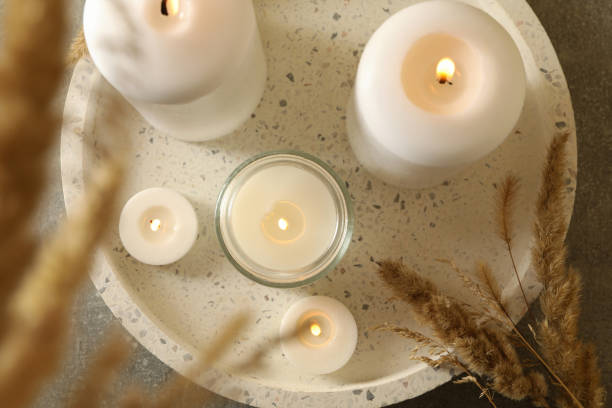 istock Tray with scented candles and reed on gray table 1295992406