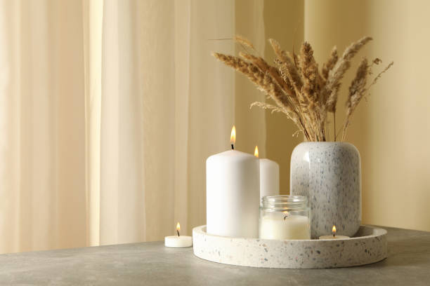 istock Tray with scented candles and reed on gray table 1295992510