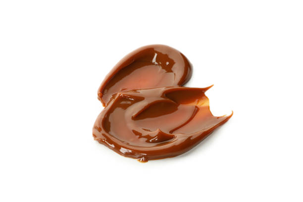 istock Caramel condensed milk isolated on white background 1295992647