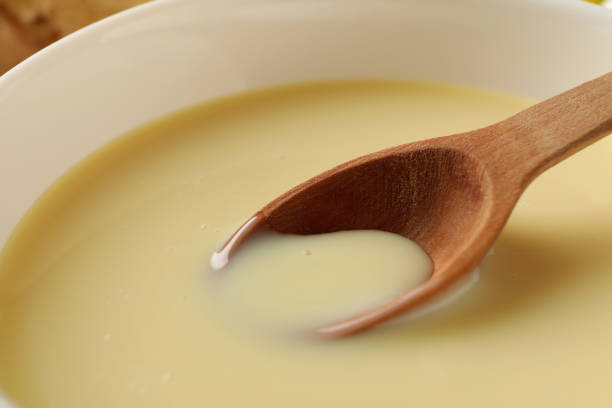 Bowl and spoon with condensed milk, close up