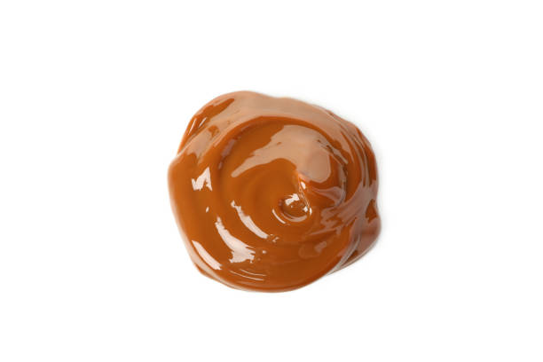 istock Caramel condensed milk isolated on white background 1295993326