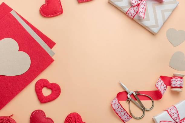 istock Workplace for making handmade decorations for Valentine's Day. Top view with free space for text. 1295993708