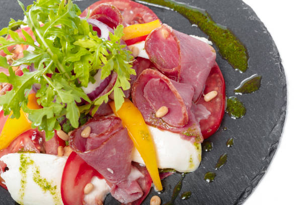 istock Fresh italian caprese salad with mozzarella and tomatoes on dark plate 1295993807