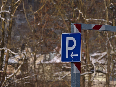 Blue colored parking sign with white \