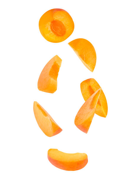 Seven pieces of falling apricot fruits isolated on withe background with clipping path as package design element and advertising stock photo