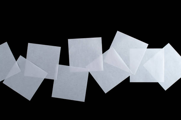istock Several sheets of white paper isolated on a black background. 1295997502