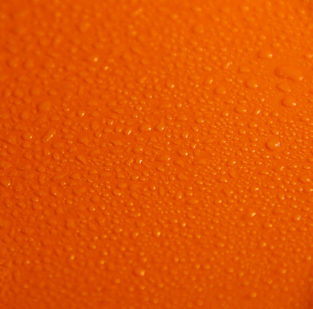 istock Wet orange background. Bright texture with water drops. 1295997583