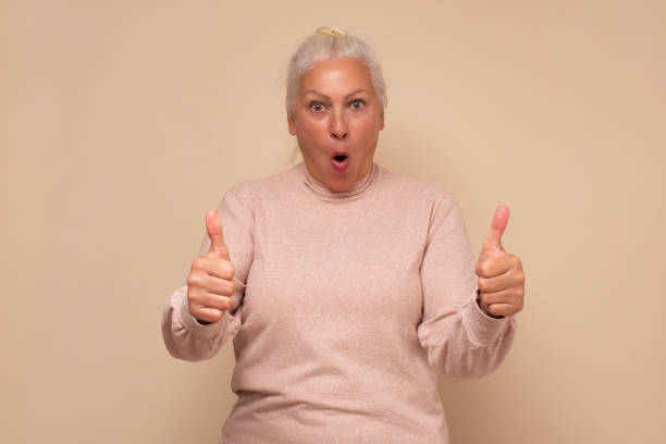 istock Active elderly woman holding her thumb up 1295997679