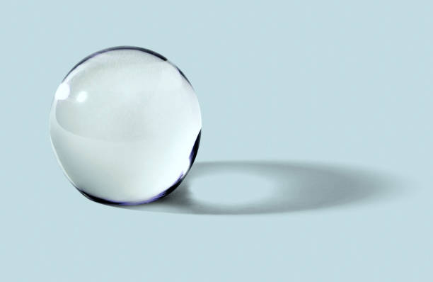 istock Glass ball or orb on blue background 1295997683
