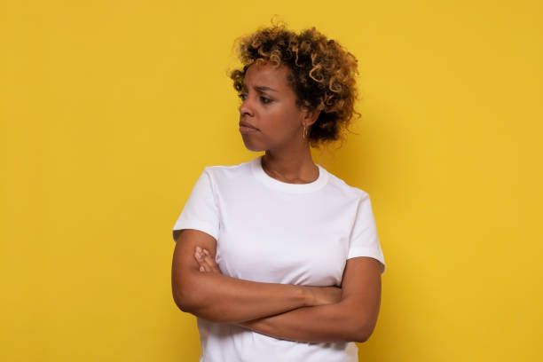 istock Serious african american woman looking aside without emotions. 1295997784