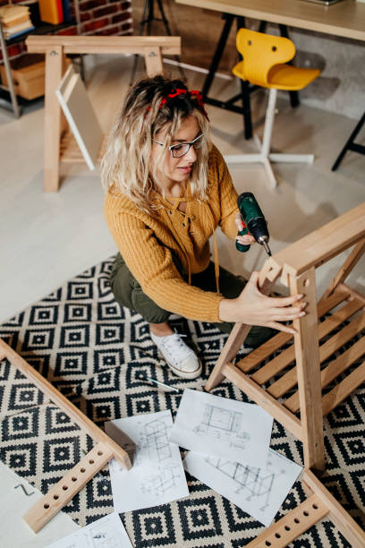 istock Young woman with drill 1295998969
