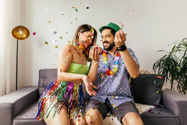 Brazilian Carnival. Couple celebrating carnival at home Brazilian Carnival. Couple celebrating carnival at home carnival celebration event photos stock pictures, royalty-free photos & images
