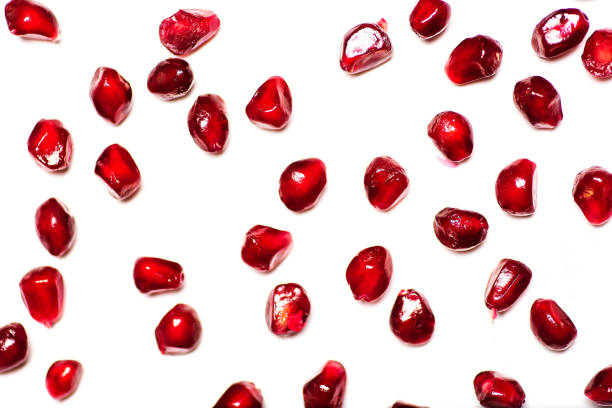 Pomegranate fruit pieces fat lay on white background top view