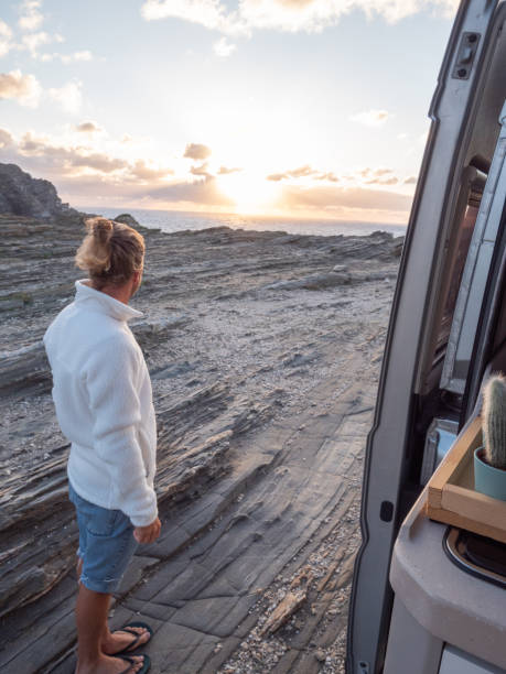 istock Man looks at coastline from his van 1295999730