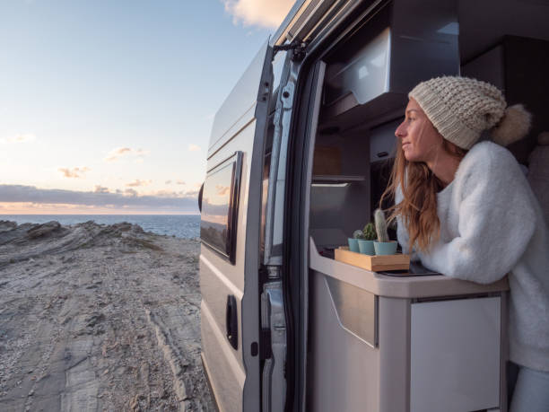 istock Woman looks at coastline from her van 1296000660