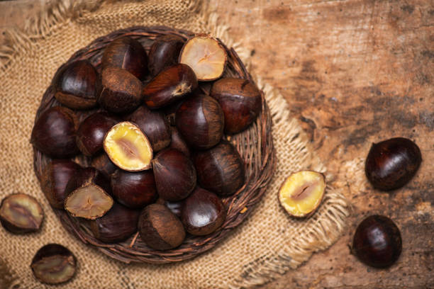 istock Raw chestnuts on a rustic plate on a wooden table 1296000942