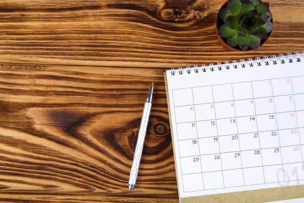 istock white calendar for 2021 month schedule to make an appointment or manage the schedule every day on a wooden table with succulent and ballpoint pen for marks, for work planning 1296001301