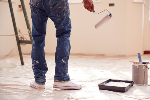 istock Close Up Of Man With Paint Roller Decorating New Home 1296002578
