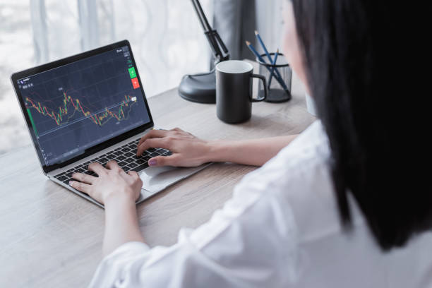 istock Woman is trading on  laptop from home. 1296003388