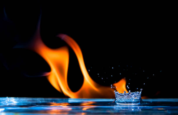 drops of water splashing on a background of fire flames