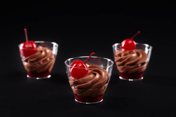 istock Glasses with jam and whipped chocolate cream layers. 1296005144