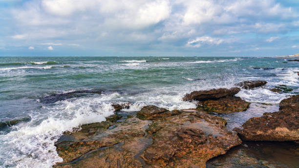 istock Wave splashing at the rocks, freshness on beach 1296006350