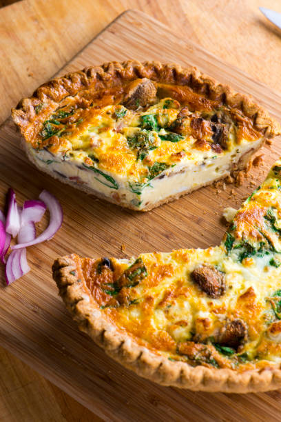 istock Quiche. Farm fresh eggs mixed with spinach, bacon, ham, sausage, cheese, vegetables poured in a pie crust and baked. Classic American restaurant or French Bistro breakfast or brunch favorite. 1296006366