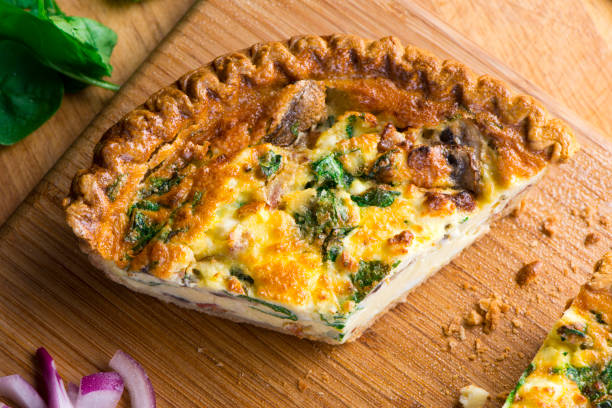 istock Quiche. Farm fresh eggs mixed with spinach, bacon, ham, sausage, cheese, vegetables poured in a pie crust and baked. Classic American restaurant or French Bistro breakfast or brunch favorite. 1296006404