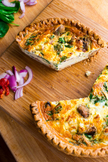 istock Quiche. Farm fresh eggs mixed with spinach, bacon, ham, sausage, cheese, vegetables poured in a pie crust and baked. Classic American restaurant or French Bistro breakfast or brunch favorite. 1296006418