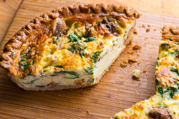 istock Quiche. Farm fresh eggs mixed with spinach, bacon, ham, sausage, cheese, vegetables poured in a pie crust and baked. Classic American restaurant or French Bistro breakfast or brunch favorite. 1296006443