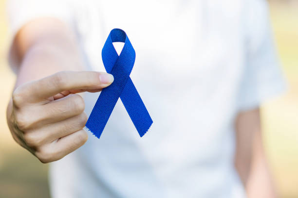 March Colorectal Cancer Awareness month, Woman holding dark Blue Ribbon for supporting people living and illness. Healthcare, hope and World cancer day concept March Colorectal Cancer Awareness month, Woman holding dark Blue Ribbon for supporting people living and illness. Healthcare, hope and World cancer day concept colorectal cancer photos stock pictures, royalty-free photos & images