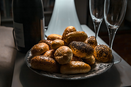 Champagne and rolls on a small table