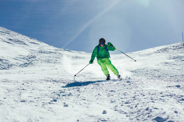 istock Young athlete freestyle Skier having fun while running downhill in beautiful landscape on sunny day during winter season 1296010552