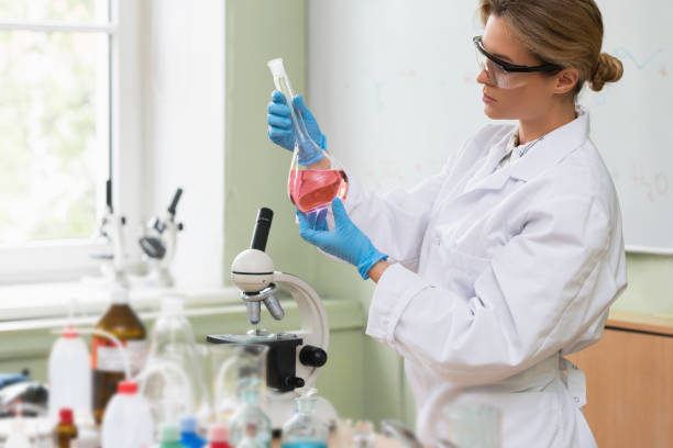 istock Scientist inspecting substance inside the flask in a laboratory 1296011956