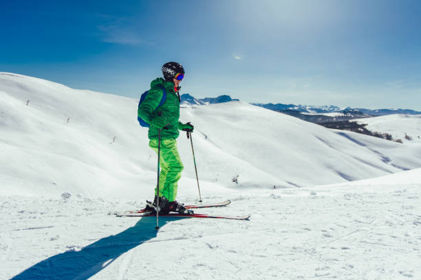 istock Young athlete freestyle Skier having fun while running downhill in beautiful landscape on sunny day during winter season 1296013272