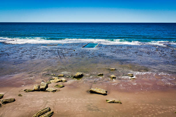 Beach at low tide in the blue sky above the rocks. Beach San Antonio Oeste Las Grutas Patagonia Argentina