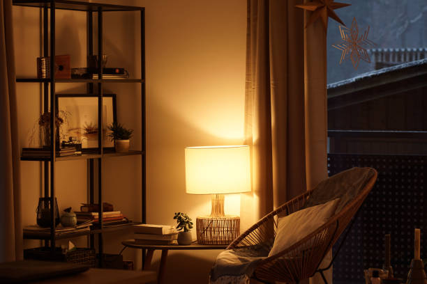 istock View of a cozy reader's corner with a table lamp spending warm light 1296013782