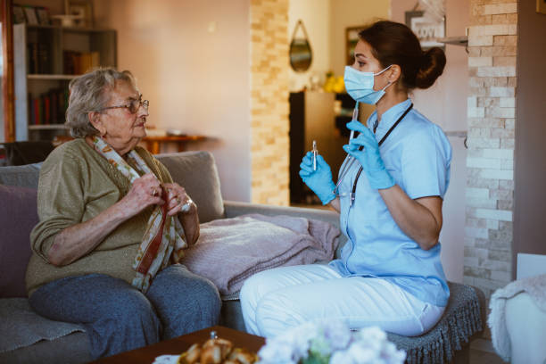 istock Senior woman is sitting during checkup. Vaccination. 1296015017